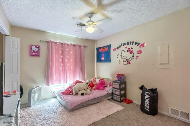 carpeted bedroom featuring a ceiling fan, a textured ceiling, visible vents, and electric panel