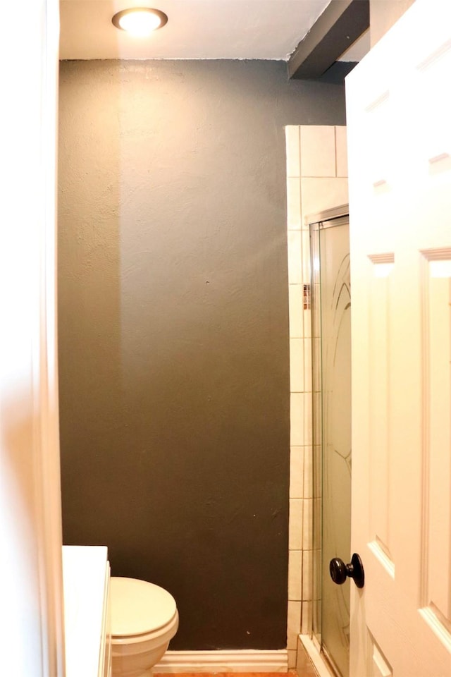 full bathroom featuring an enclosed shower and toilet
