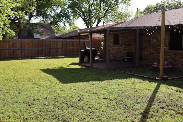 view of yard with fence and a patio area