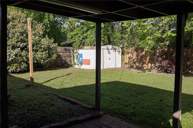 view of yard featuring a fenced backyard, an outbuilding, and a storage shed