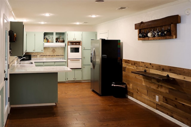 kitchen featuring open shelves, visible vents, light countertops, ornamental molding, and stainless steel fridge