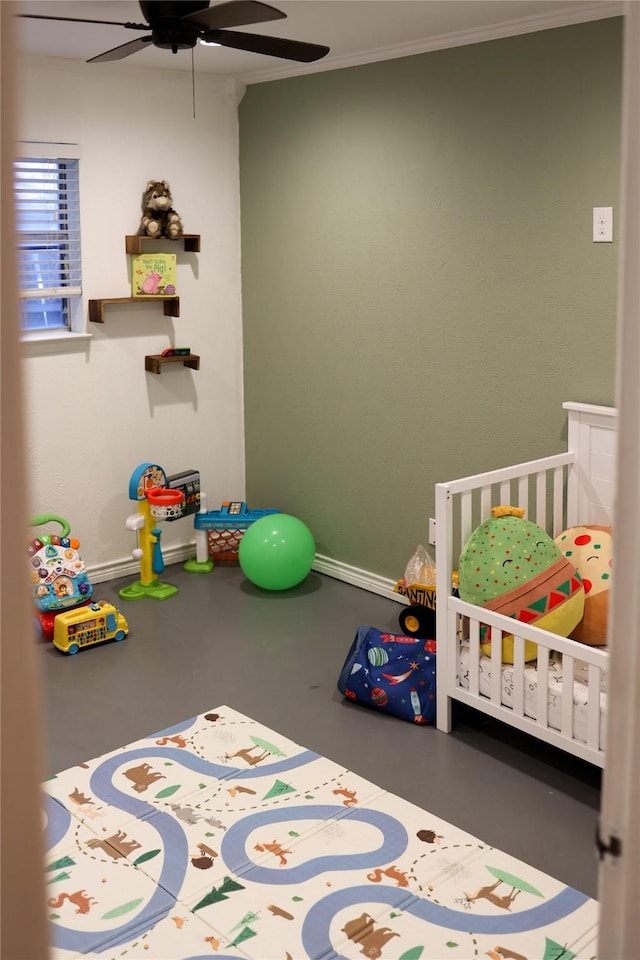 bedroom with crown molding, concrete floors, a ceiling fan, and a nursery area