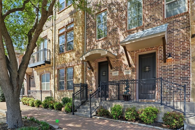 doorway to property with brick siding