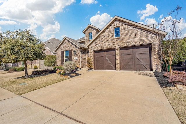 view of front of home with brick siding, a garage, and concrete driveway