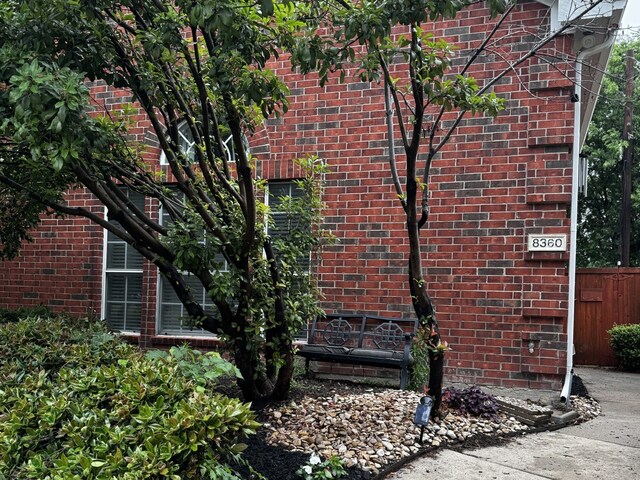 view of side of property with brick siding