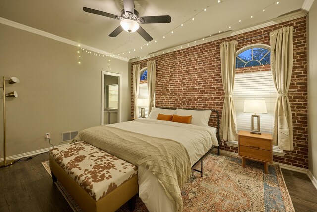 bedroom featuring baseboards, brick wall, and visible vents