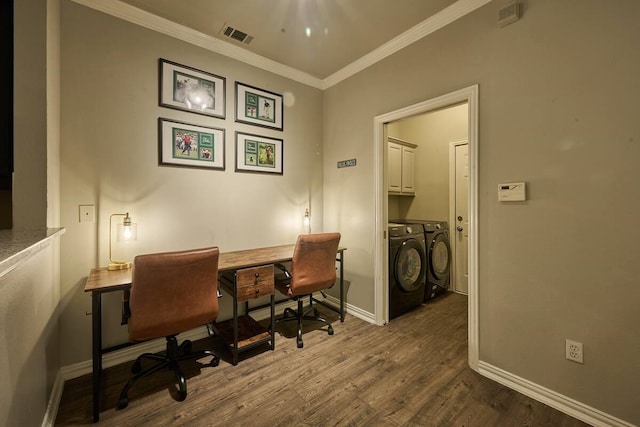 home office featuring visible vents, wood finished floors, baseboards, separate washer and dryer, and ornamental molding