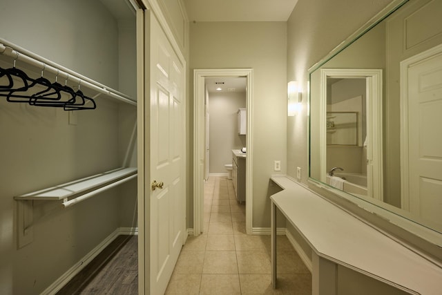 bathroom featuring tile patterned floors, baseboards, and toilet
