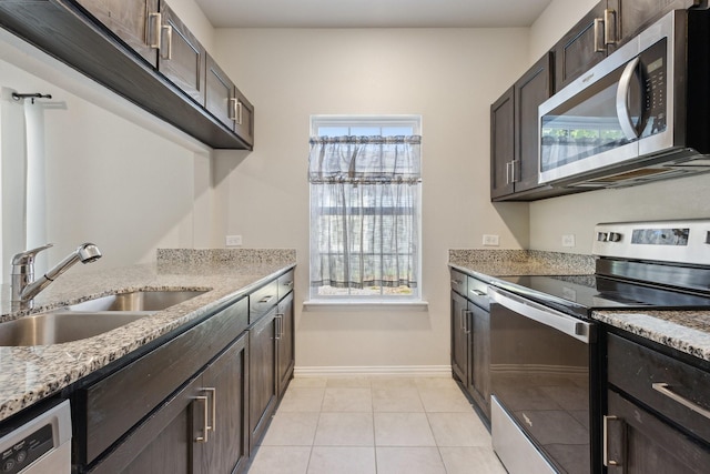 4538 Cherbourg St, Dallas, TX 75216 - kitchen featuring appliances with stainless steel finishes, a sink, healthy amount of natural light, and dark brown cabinetry