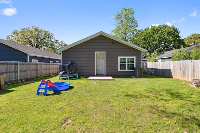 4538 Cherbourg St, Dallas, TX 75216 - rear view of property with a trampoline and central AC unit