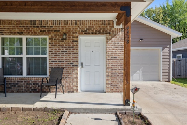 4538 Cherbourg St, Dallas, TX 75216 - doorway to property featuring brick siding, concrete driveway, and a garage