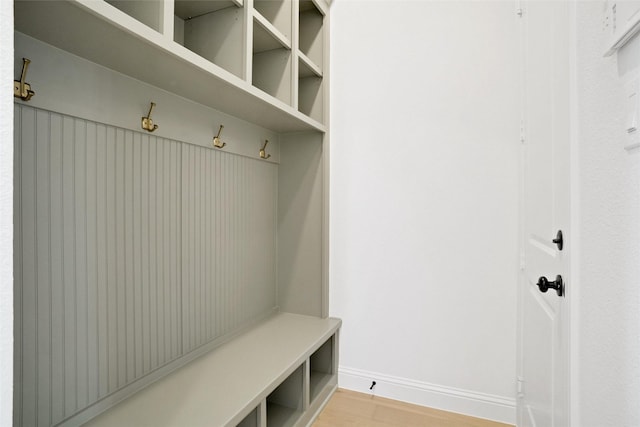 mudroom featuring light wood-style floors and baseboards