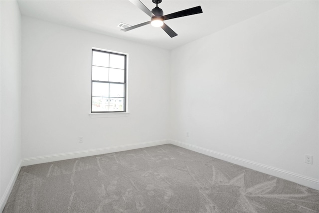 spare room with visible vents, baseboards, a ceiling fan, and carpet