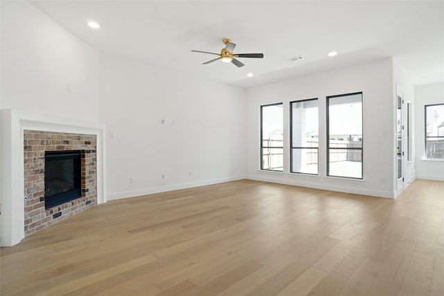 unfurnished living room featuring a ceiling fan, visible vents, recessed lighting, light wood finished floors, and baseboards