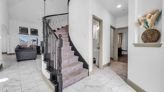 304 Winding Creek Ln, Anna, TX 75409 - stairway with arched walkways, baseboards, marble finish floor, and a high ceiling