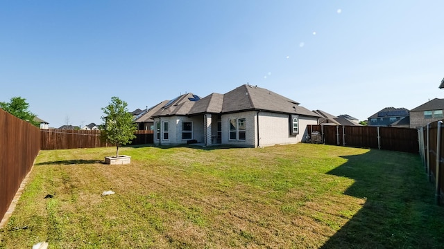 304 Winding Creek Ln, Anna, TX 75409 - back of property featuring a yard, a fenced backyard, and brick siding