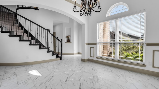 304 Winding Creek Ln, Anna, TX 75409 - entryway with a wealth of natural light, arched walkways, marble finish floor, and baseboards