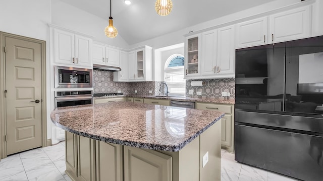 304 Winding Creek Ln, Anna, TX 75409 - kitchen featuring tasteful backsplash, appliances with stainless steel finishes, under cabinet range hood, vaulted ceiling, and marble finish floor