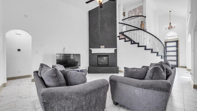 304 Winding Creek Ln, Anna, TX 75409 - living area with arched walkways, stairs, marble finish floor, and ceiling fan with notable chandelier