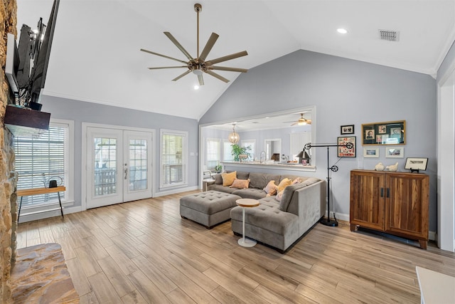 living room featuring high vaulted ceiling, a ceiling fan, light wood finished floors, and visible vents