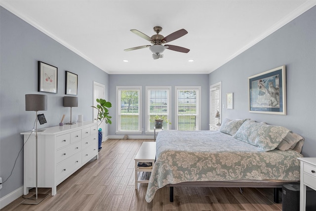 bedroom with light wood-type flooring, baseboards, and ornamental molding