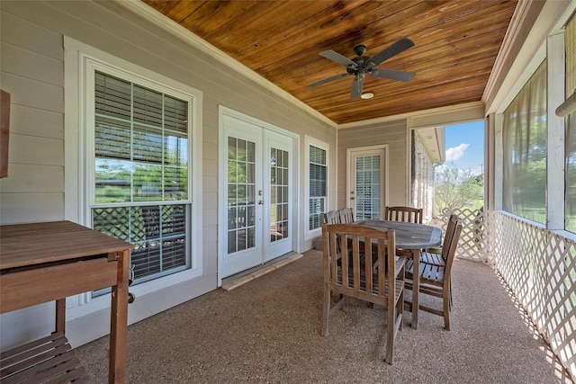 sunroom featuring french doors, outdoor dining area, and ceiling fan