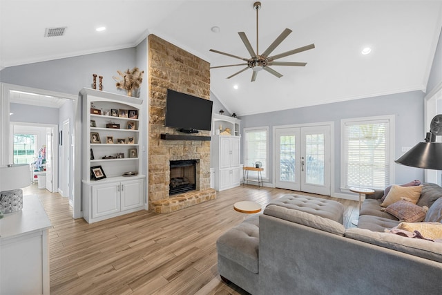 living room featuring visible vents, a ceiling fan, ornamental molding, french doors, and light wood-style flooring