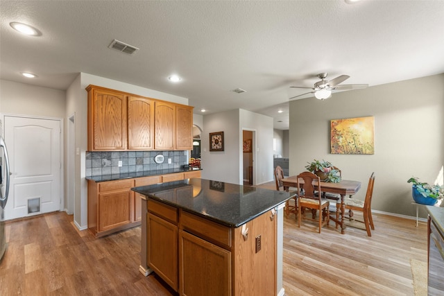 3101 Clear Springs Dr, Forney, TX 75126 - kitchen with visible vents, backsplash, light wood-type flooring, and a center island