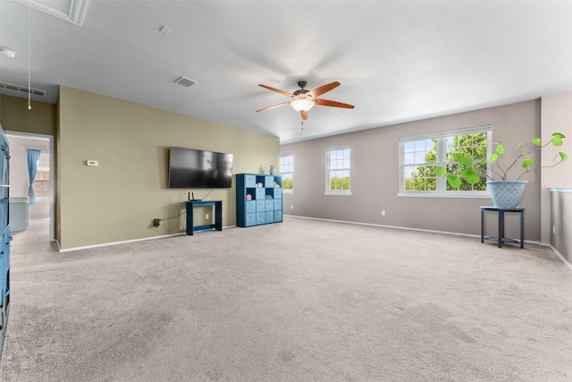 3101 Clear Springs Dr, Forney, TX 75126 - unfurnished living room with visible vents, baseboards, ceiling fan, carpet, and attic access
