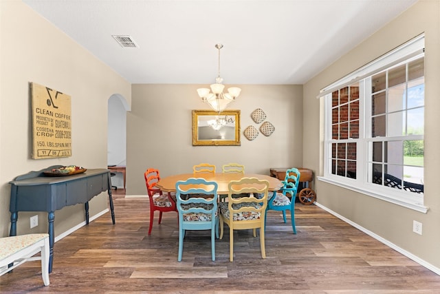 3101 Clear Springs Dr, Forney, TX 75126 - dining room with an inviting chandelier, arched walkways, visible vents, wood finished floors, and baseboards