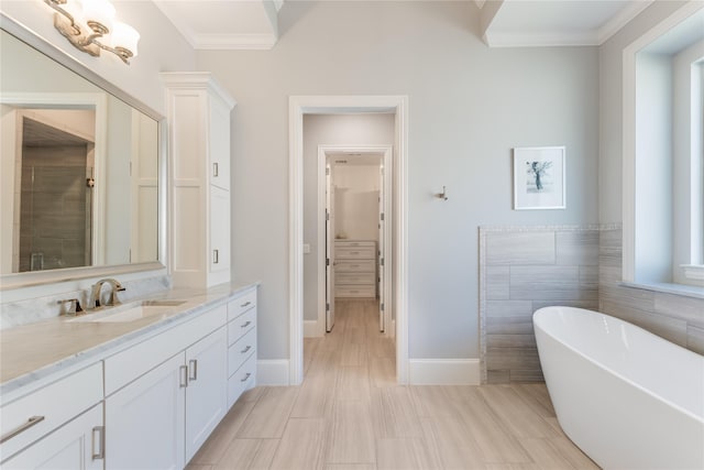 924 Winding Ridge Trl, Southlake, TX 76092 - bathroom featuring ornamental molding, vanity, a soaking tub, and baseboards