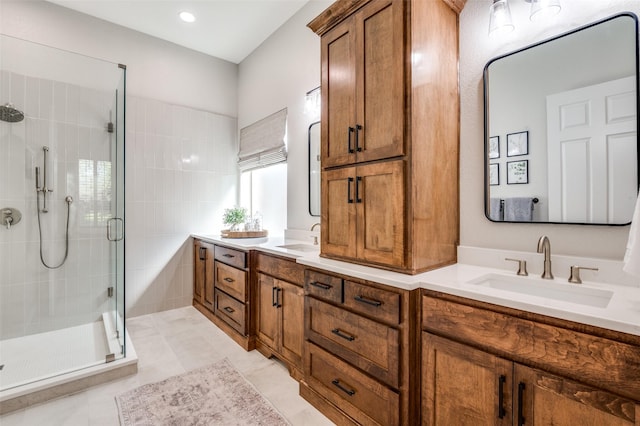 full bathroom featuring a shower stall, double vanity, and a sink