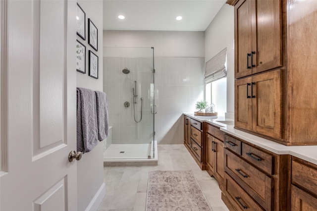 full bath with a stall shower, vanity, and recessed lighting