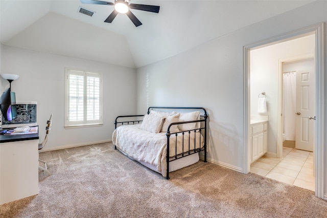 carpeted bedroom with ceiling fan, visible vents, vaulted ceiling, tile patterned floors, and baseboards
