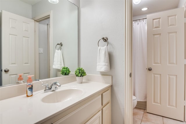 full bathroom with tile patterned flooring, vanity, and toilet