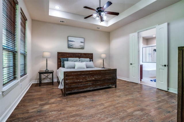 317 Joplin Dr, Mckinney, TX 75071 - bedroom with wood finished floors, a tray ceiling, recessed lighting, baseboards, and ensuite bath