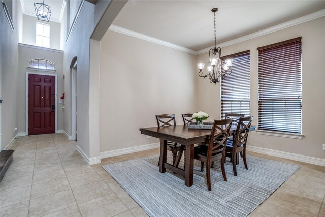 317 Joplin Dr, Mckinney, TX 75071 - dining area with a chandelier, light tile patterned flooring, arched walkways, crown molding, and baseboards