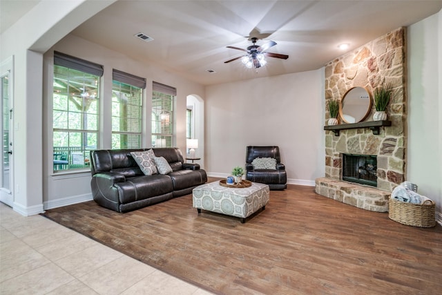 317 Joplin Dr, Mckinney, TX 75071 - living area with arched walkways, a ceiling fan, a fireplace, baseboards, and wood finished floors