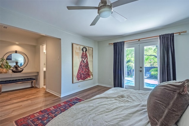 bedroom featuring access to outside, baseboards, french doors, a ceiling fan, and wood finished floors