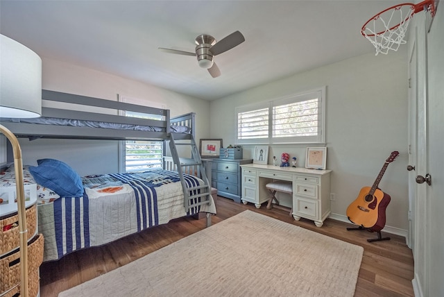 bedroom with baseboards, a ceiling fan, and dark wood finished floors