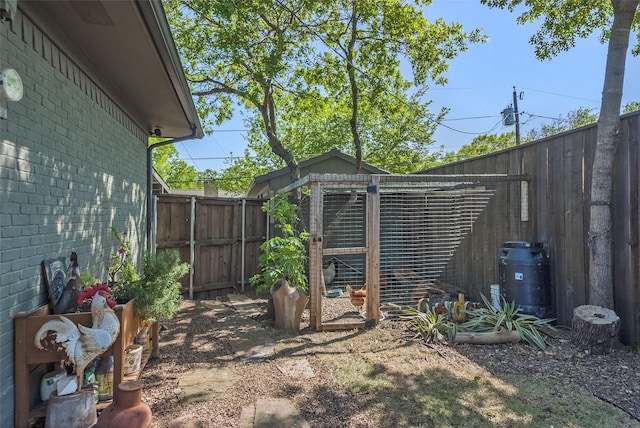 view of yard featuring an outbuilding and a fenced backyard