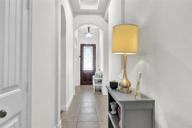 1124 Spanish Moss Dr, Savannah, TX 76227 - entryway featuring arched walkways, light tile patterned floors, and baseboards
