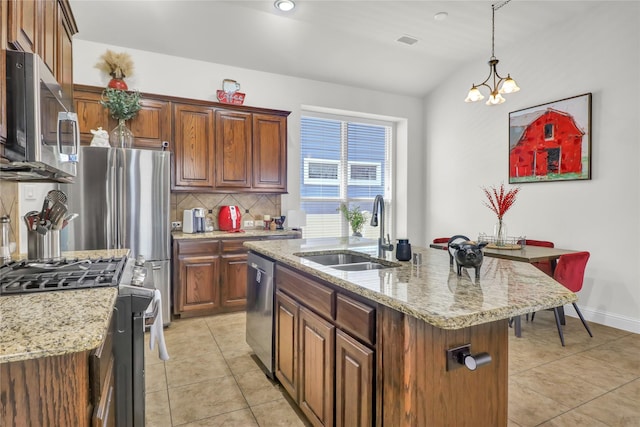 1124 Spanish Moss Dr, Savannah, TX 76227 - kitchen with light tile patterned floors, light stone countertops, tasteful backsplash, appliances with stainless steel finishes, and a sink