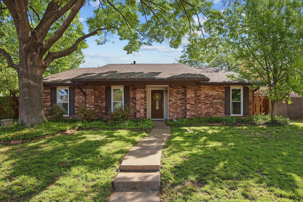 6310 Galaxie Rd, Garland, TX 75044 - single story home featuring brick siding, a front lawn, and fence