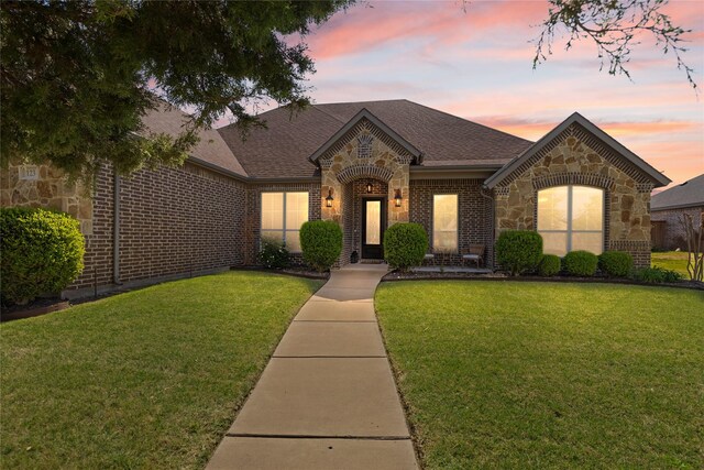 123 Claremont Dr, Ovilla, TX 75154 - french country inspired facade with brick siding, a front yard, roof with shingles, and stone siding