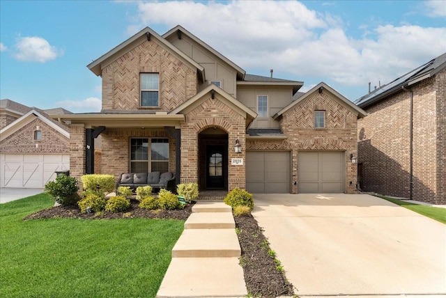 2605 High Bluff Dr, Mansfield, TX 76063 - view of front of home featuring a garage, a front yard, stucco siding, brick siding, and driveway