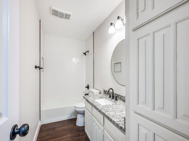 bathroom with visible vents, toilet, shower / bath combination, vanity, and wood finished floors