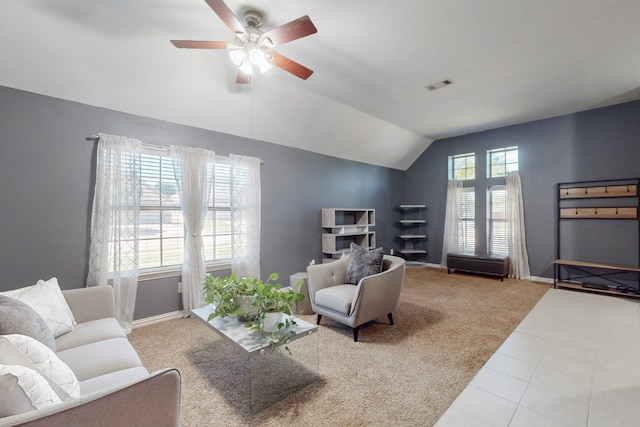 living room with vaulted ceiling, tile patterned floors, carpet floors, visible vents, and ceiling fan
