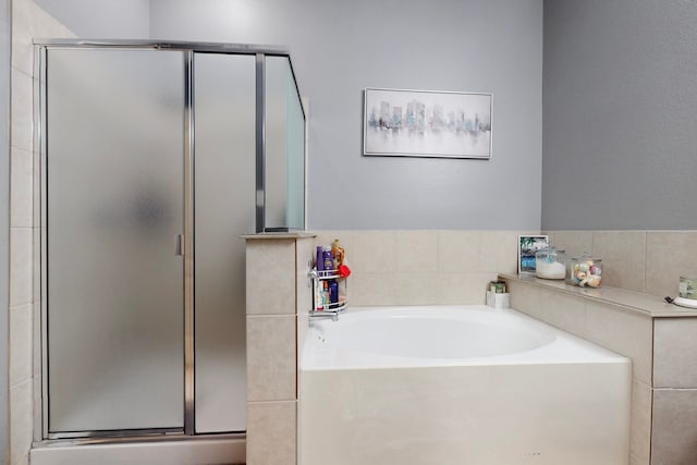 full bathroom with a bath and a stall shower
