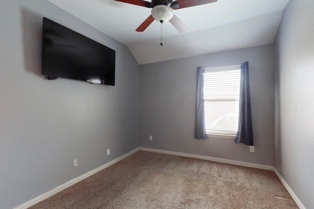spare room with carpet flooring, baseboards, a ceiling fan, and lofted ceiling